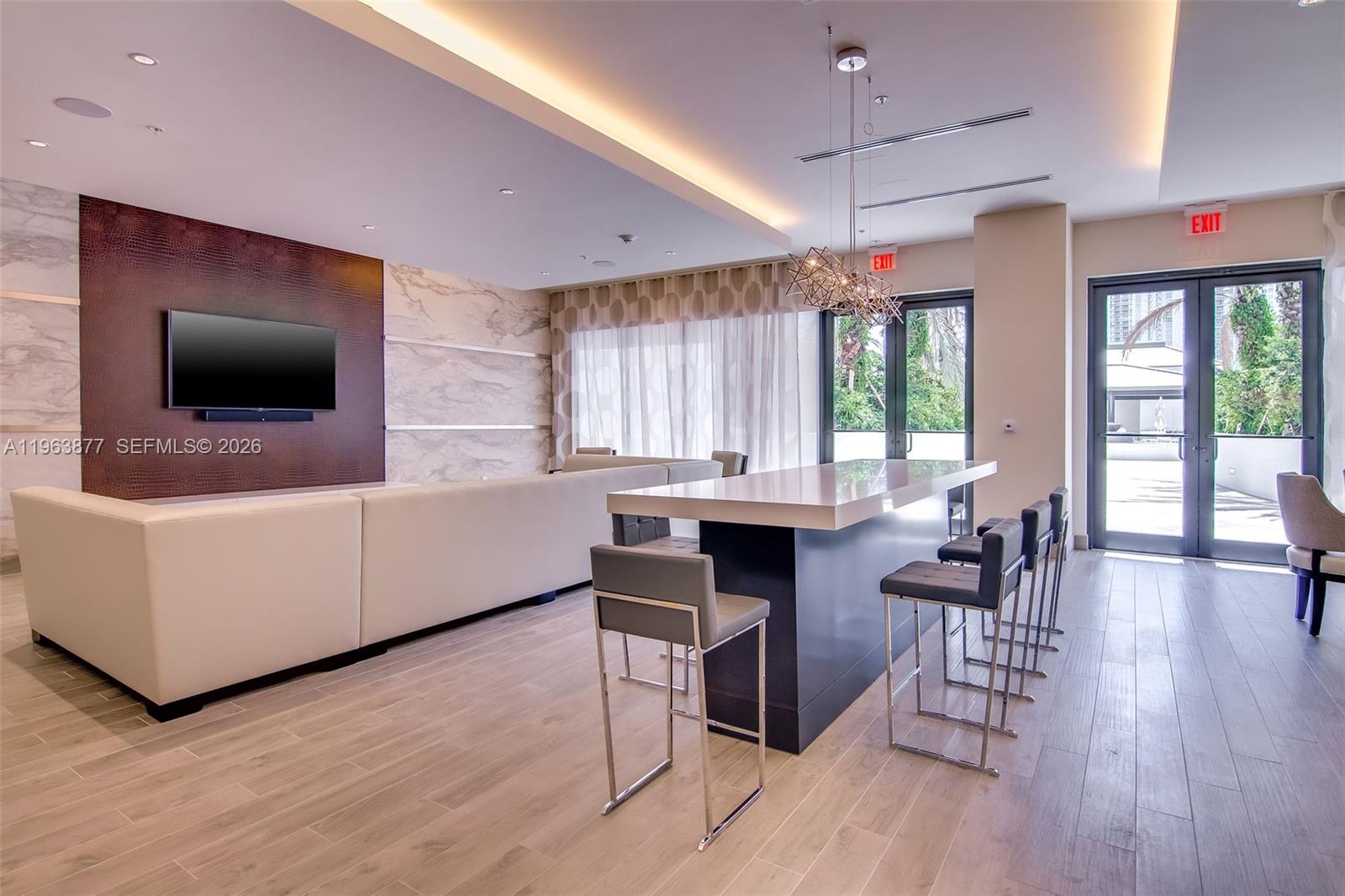 999 Southwest 1st Avenue, Unit 2303 Miami, FL 33130 - Photo 27 of 44 a living room with furniture and a flat screen tv