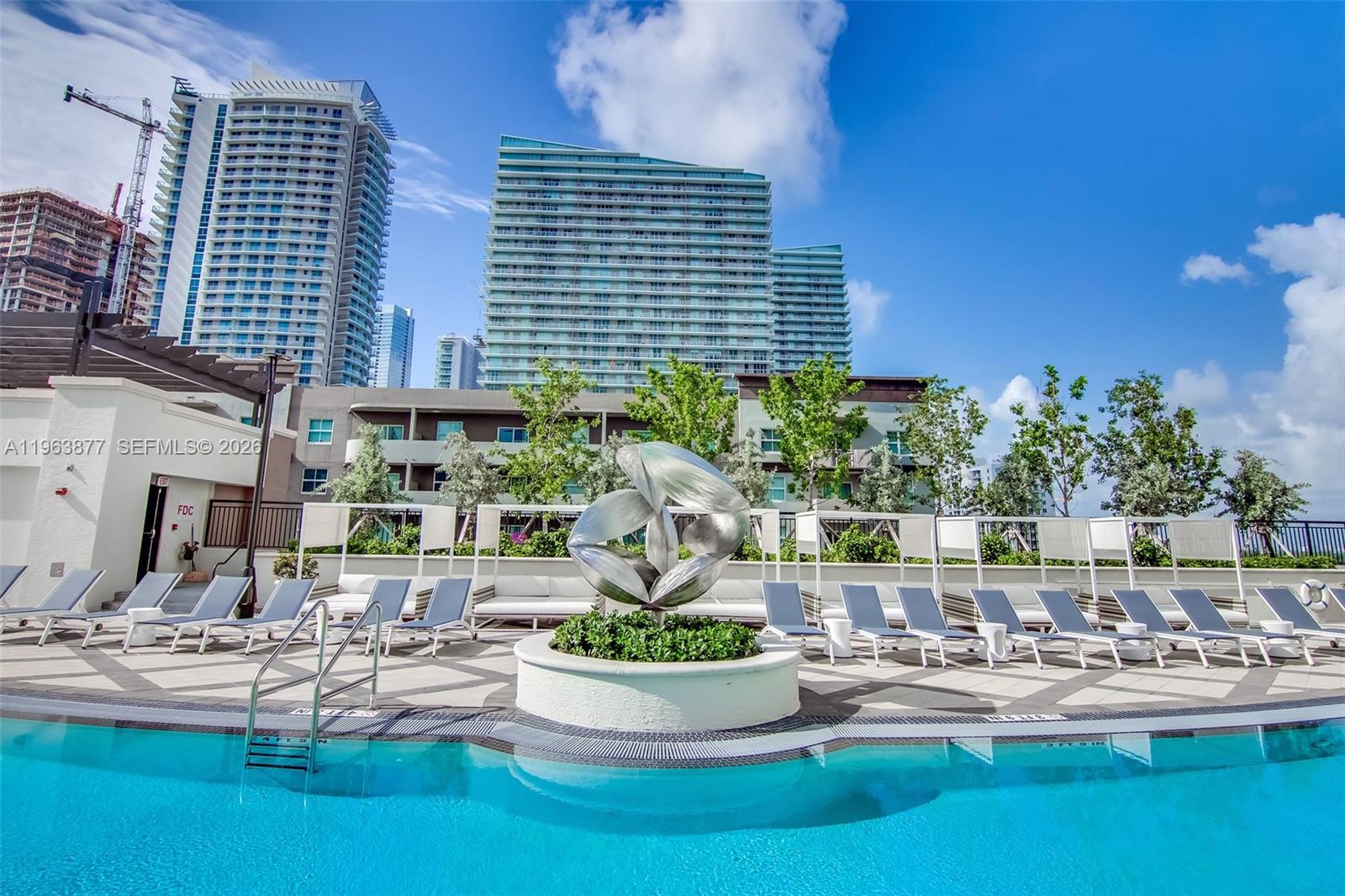 999 Southwest 1st Avenue, Unit 2303 Miami, FL 33130 - Photo 38 of 44 a view of a swimming pool with outdoor seating