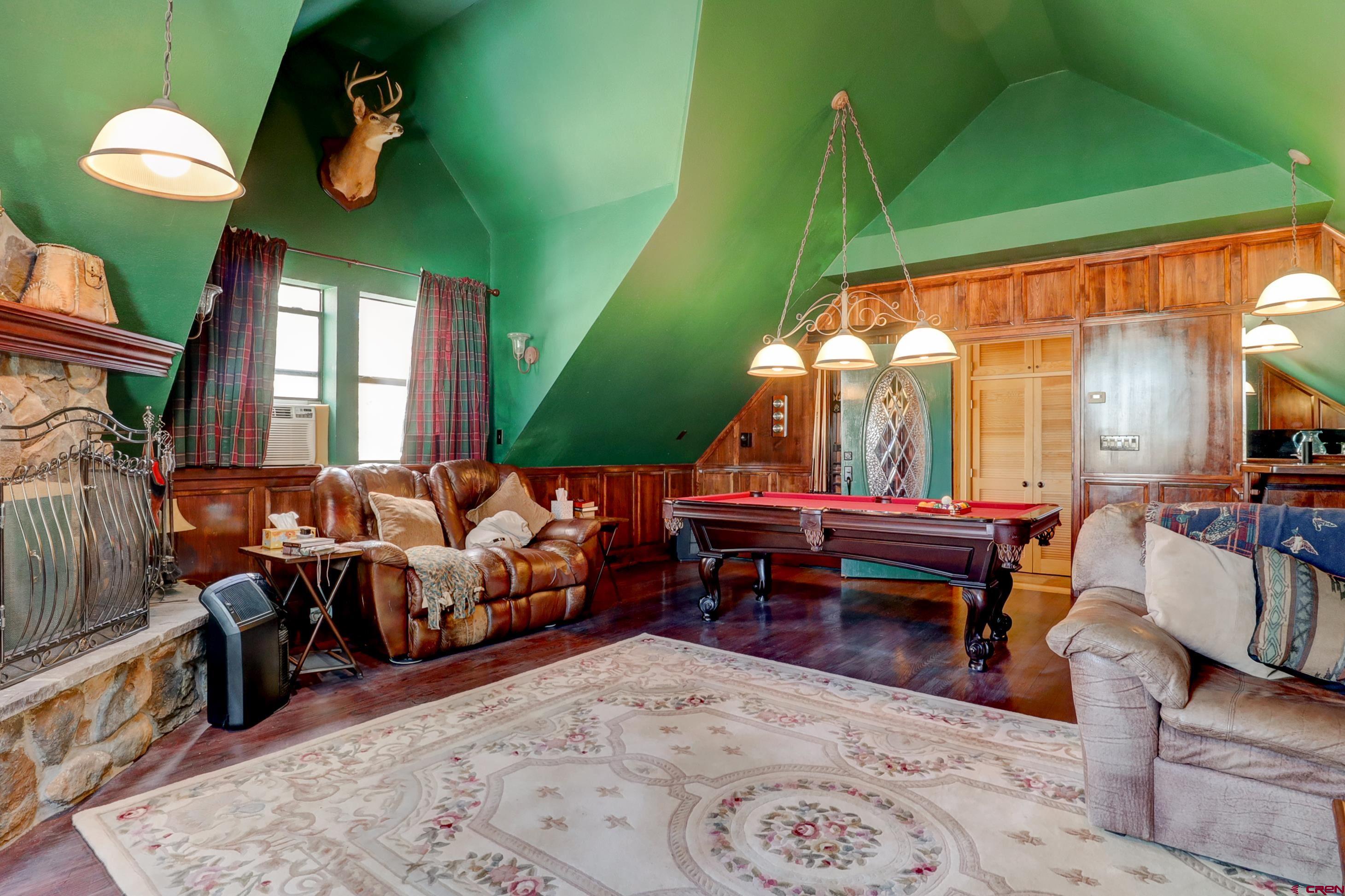 18656 Highway 145 Dolores, CO 81323 - Photo 14 of 45 Rec room with wood walls, high vaulted ceiling, billiards, and wood finished floors