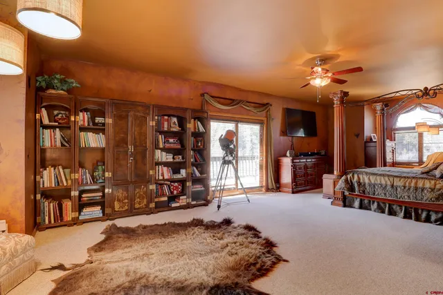 a bedroom with furniture and a chandelier