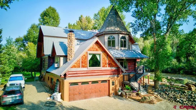 an aerial view of a house with a yard and sitting area