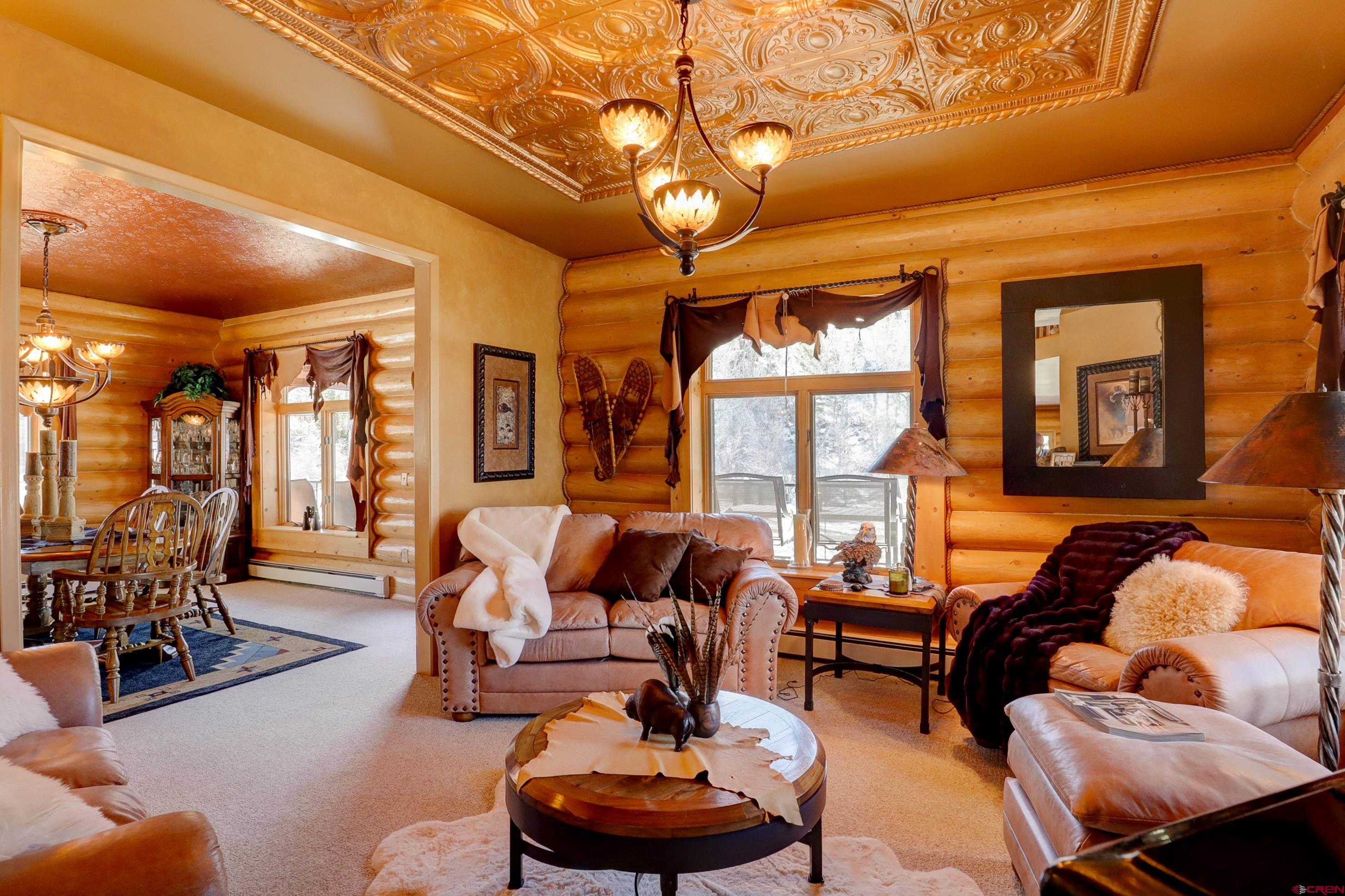 18656 Highway 145 Dolores, CO 81323 - Photo 8 of 45 Carpeted living room featuring baseboard heating and a chandelier