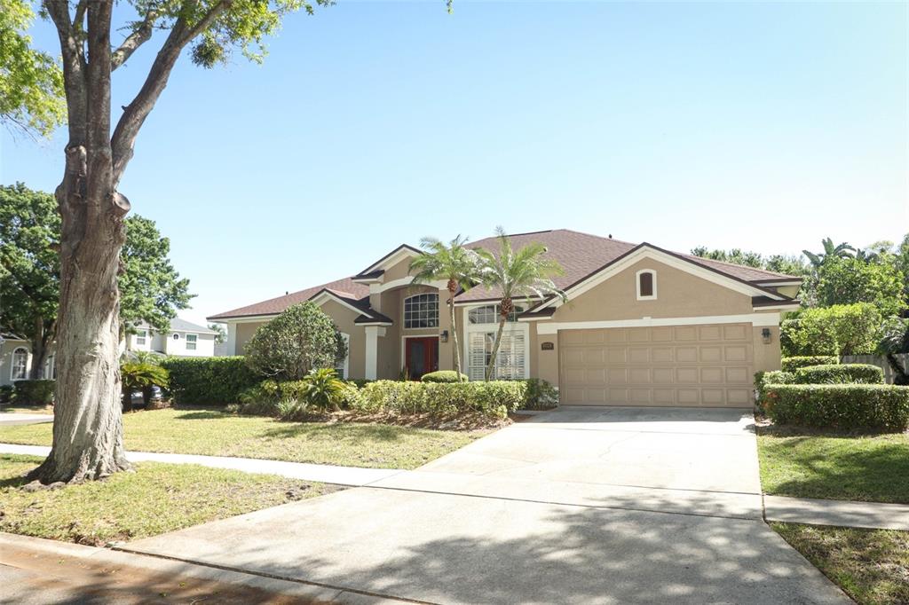 a front view of a house with a yard and garage