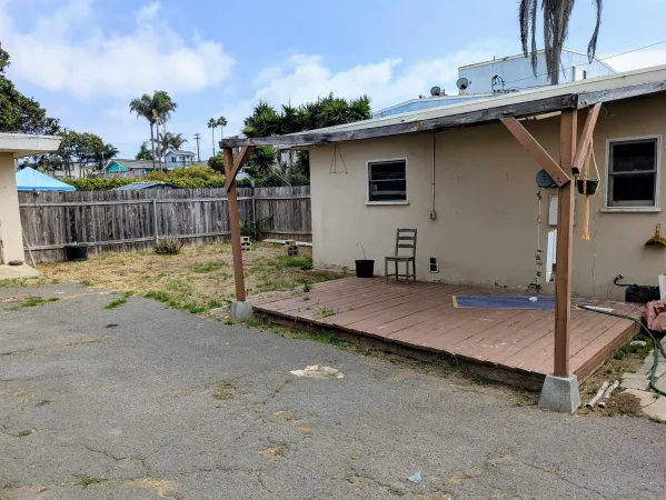 a view of a backyard with wooden fence