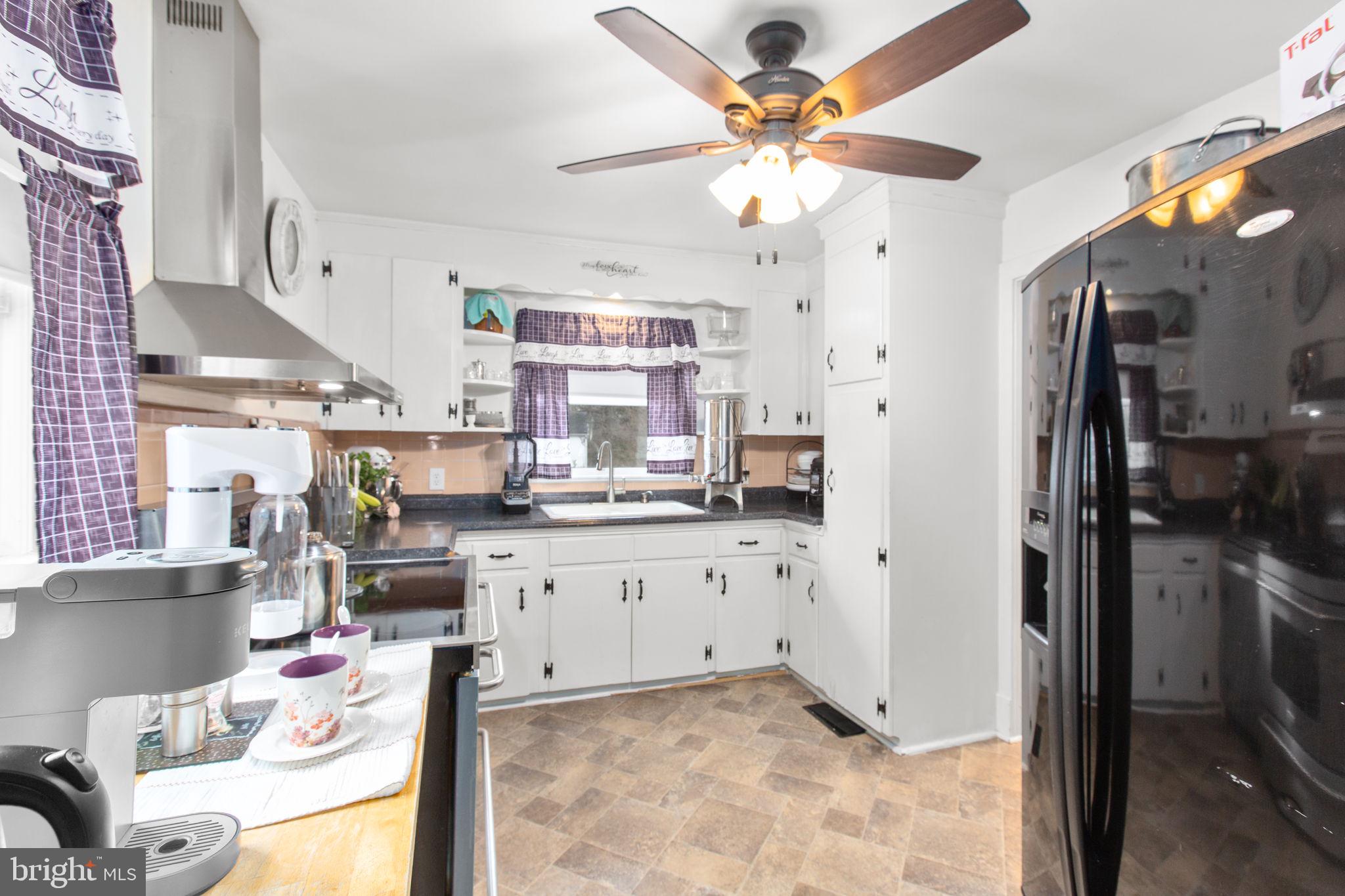 80 Ferry Road Fredericksburg, VA 22405 - Photo 11 of 39 a kitchen with stainless steel appliances kitchen island granite countertop a refrigerator a stove a sink and dishwasher