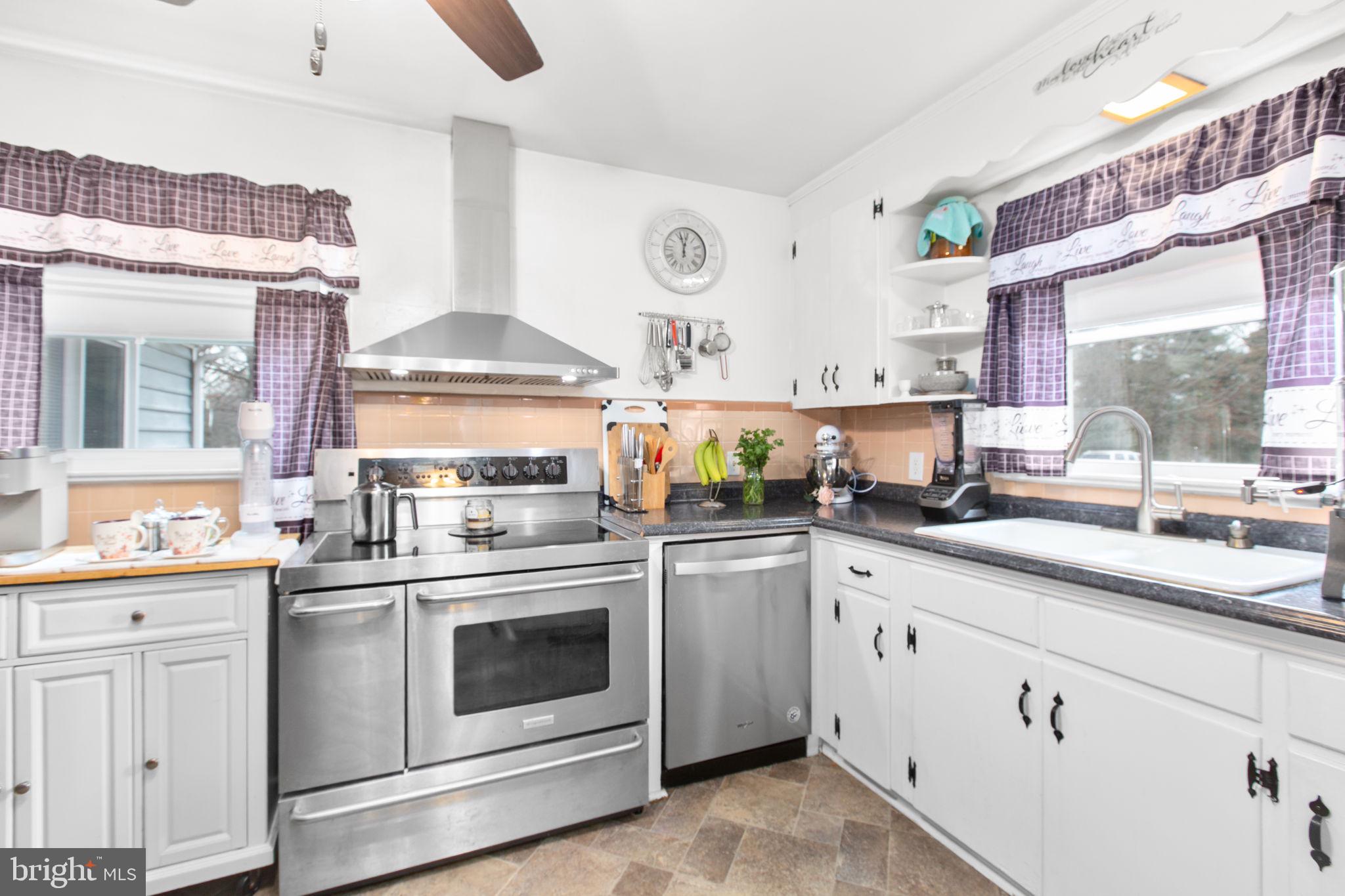 80 Ferry Road Fredericksburg, VA 22405 - Photo 9 of 39 a kitchen with granite countertop white cabinets and white stainless steel appliances