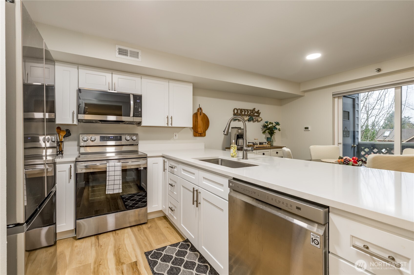 a kitchen with a sink stove and microwave