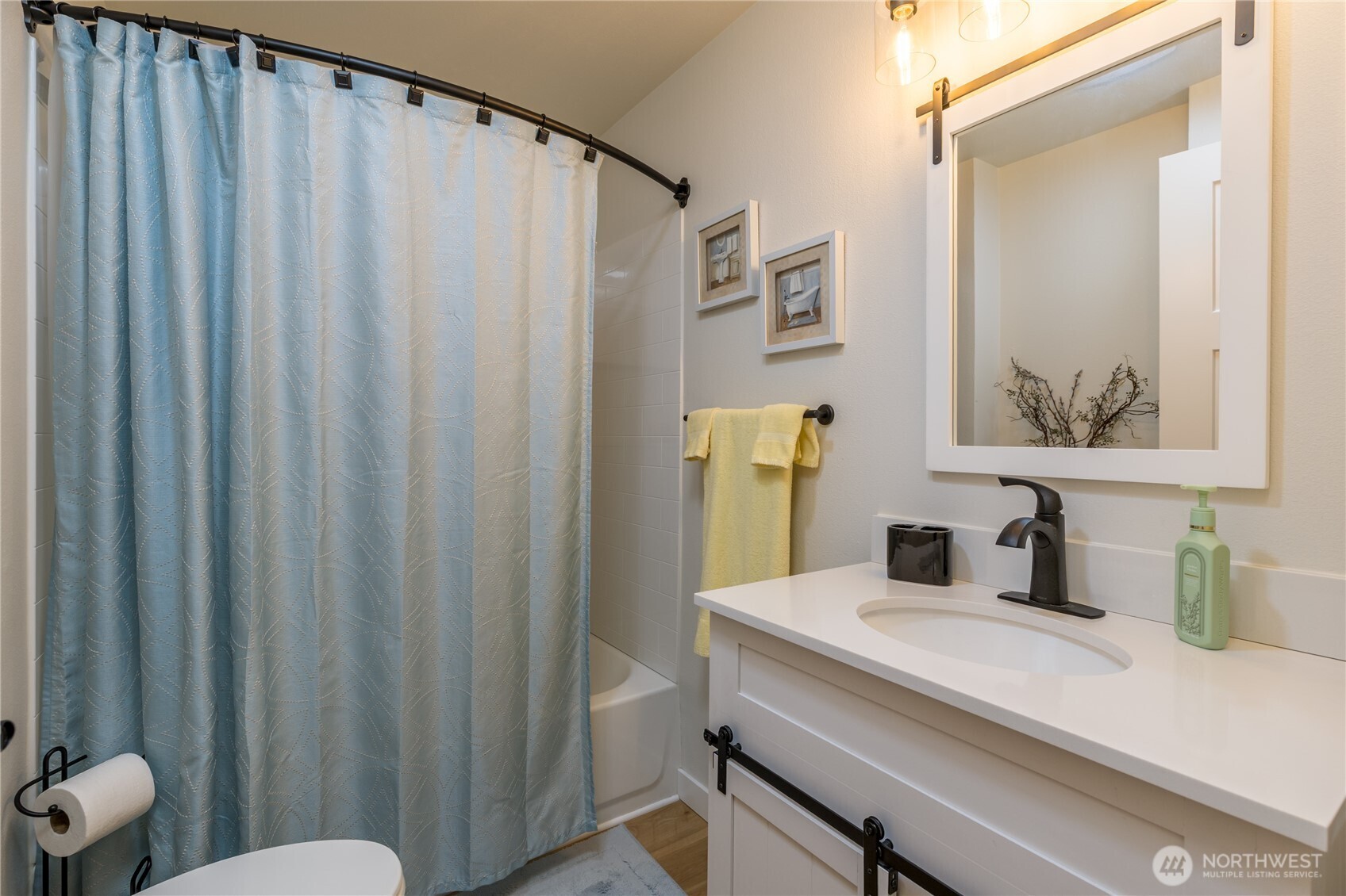 3939 10th Street Southeast, Unit B4 Puyallup, WA 98374 - Photo 19 of 25 a bathroom with a sink a toilet and shower curtain