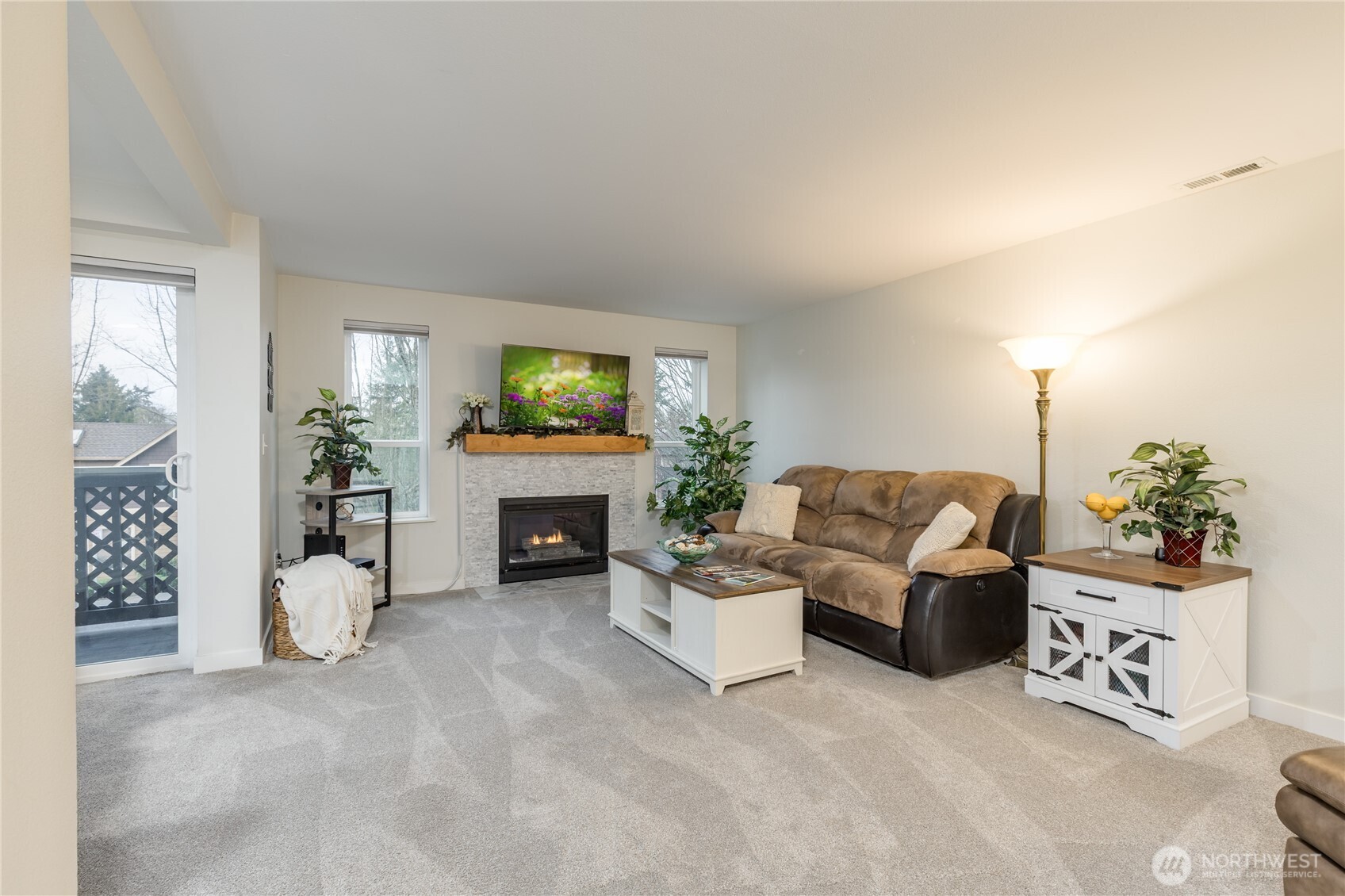 3939 10th Street Southeast, Unit B4 Puyallup, WA 98374 - Photo 4 of 25 a living room with furniture a fireplace and a flat screen tv