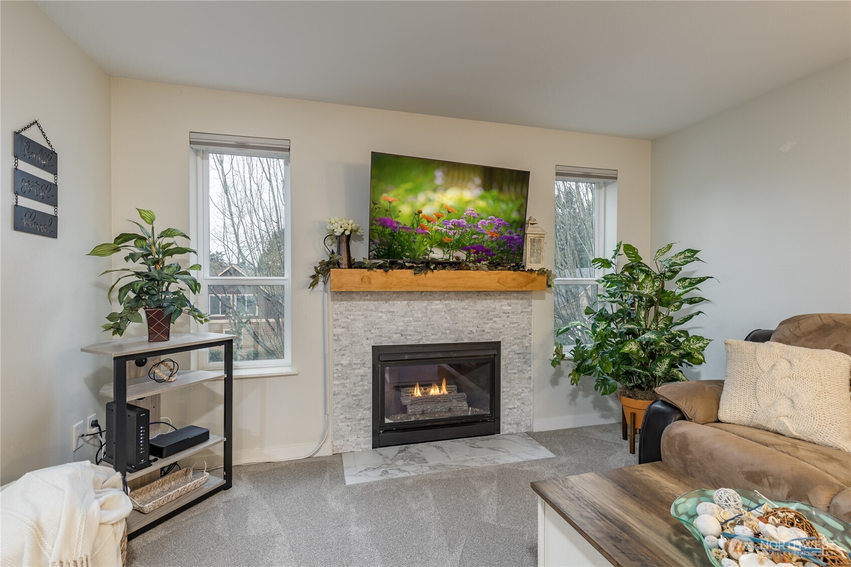 3939 10th Street Southeast, Unit B4 Puyallup, WA 98374 - Photo 5 of 25 a living room with furniture and a fireplace