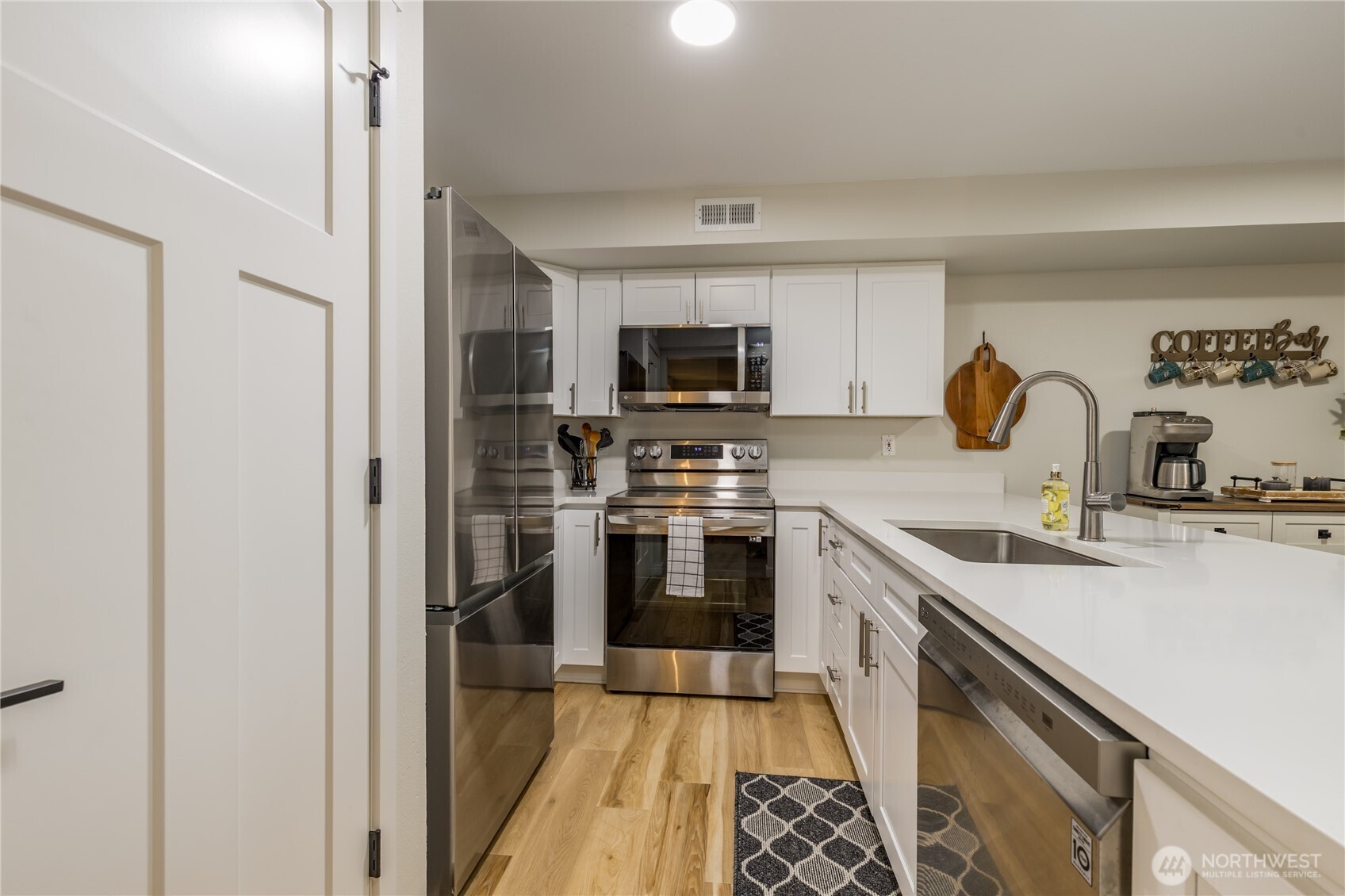 3939 10th Street Southeast, Unit B4 Puyallup, WA 98374 - Photo 6 of 25 a kitchen with a sink a stove and refrigerator