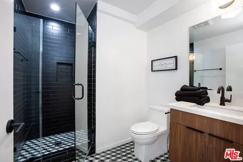 a bathroom with a toilet a sink and shower