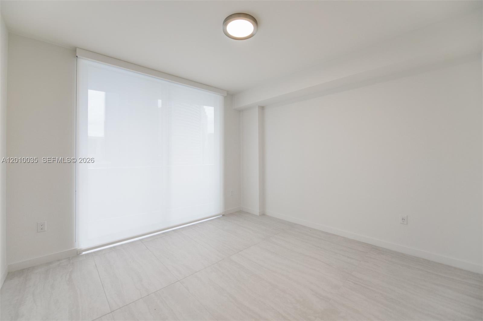 77 Southeast 5th Street, Unit 2603 Miami, FL 33131 - Photo 13 of 67 an empty room with a empty space and window