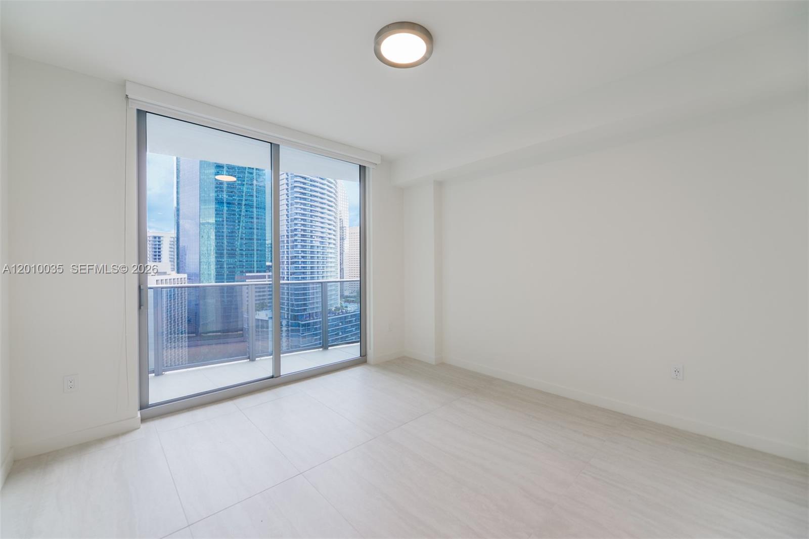 77 Southeast 5th Street, Unit 2603 Miami, FL 33131 - Photo 14 of 67 an empty room with sliding glass door and shower