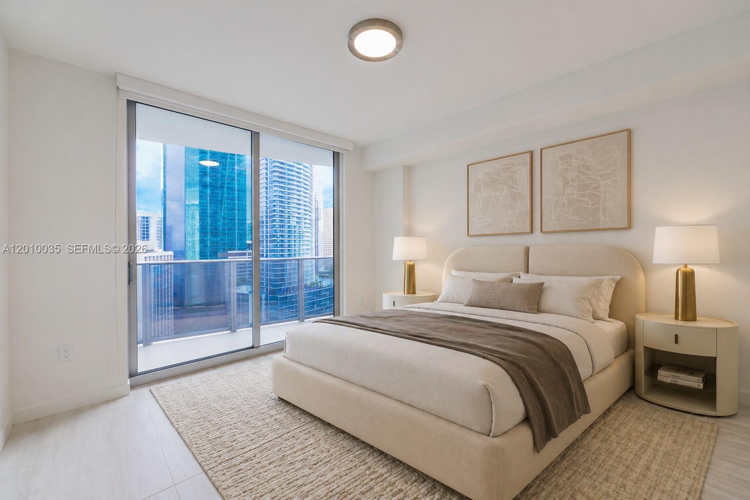 77 Southeast 5th Street, Unit 2603 Miami, FL 33131 - Photo 15 of 67 a bedroom with a bed and a view of bathroom