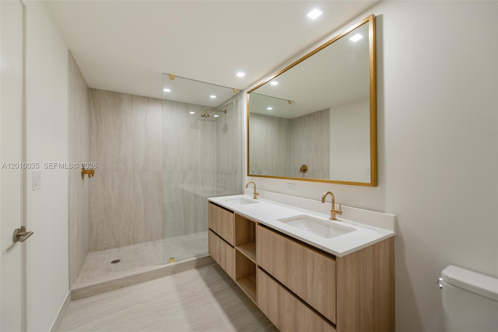 77 Southeast 5th Street, Unit 2603 Miami, FL 33131 - Photo 21 of 67 a bathroom with a sink double vanity and shower