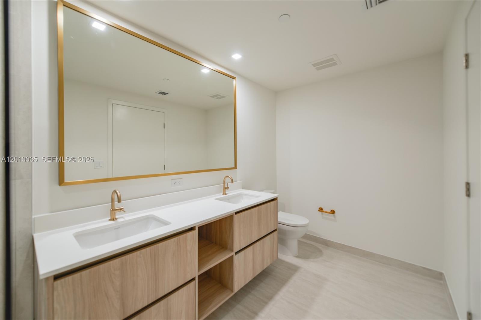 77 Southeast 5th Street, Unit 2603 Miami, FL 33131 - Photo 22 of 67 a bathroom with a sink and a mirror