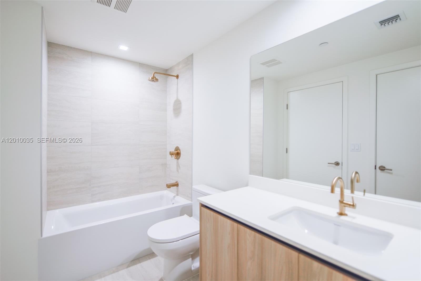 77 Southeast 5th Street, Unit 2603 Miami, FL 33131 - Photo 24 of 67 a bathroom with a sink a toilet and a bathtub