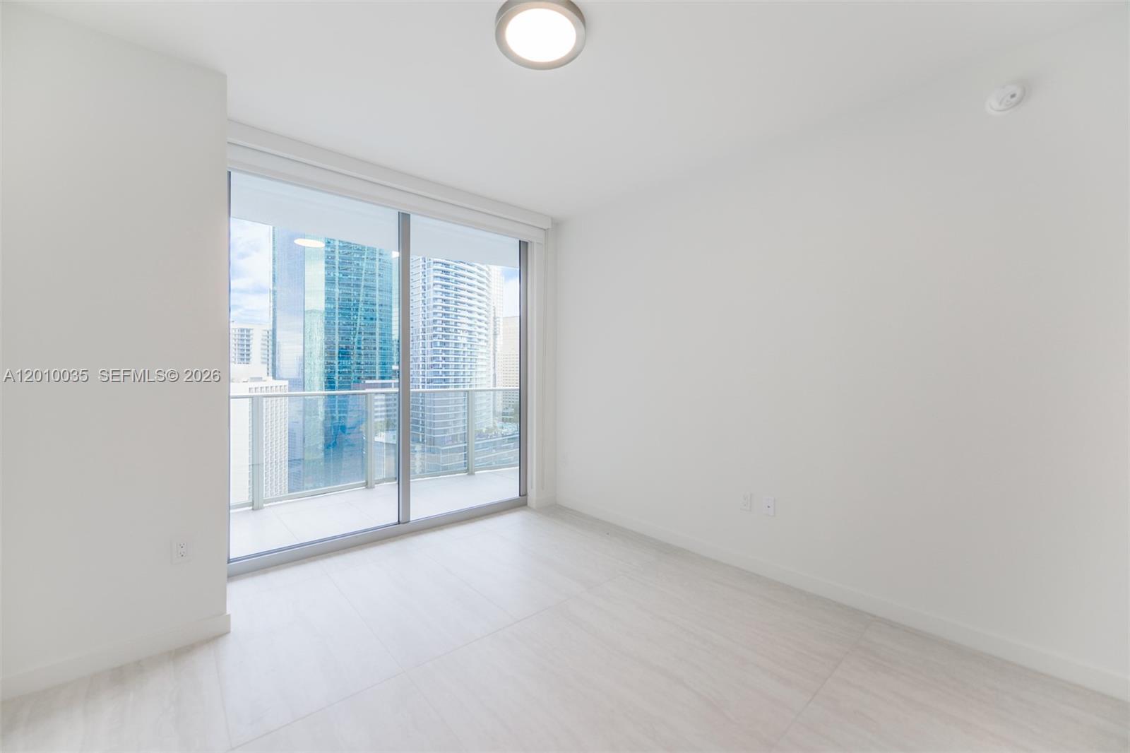 77 Southeast 5th Street, Unit 2603 Miami, FL 33131 - Photo 28 of 67 a view of empty room with floor to ceiling window