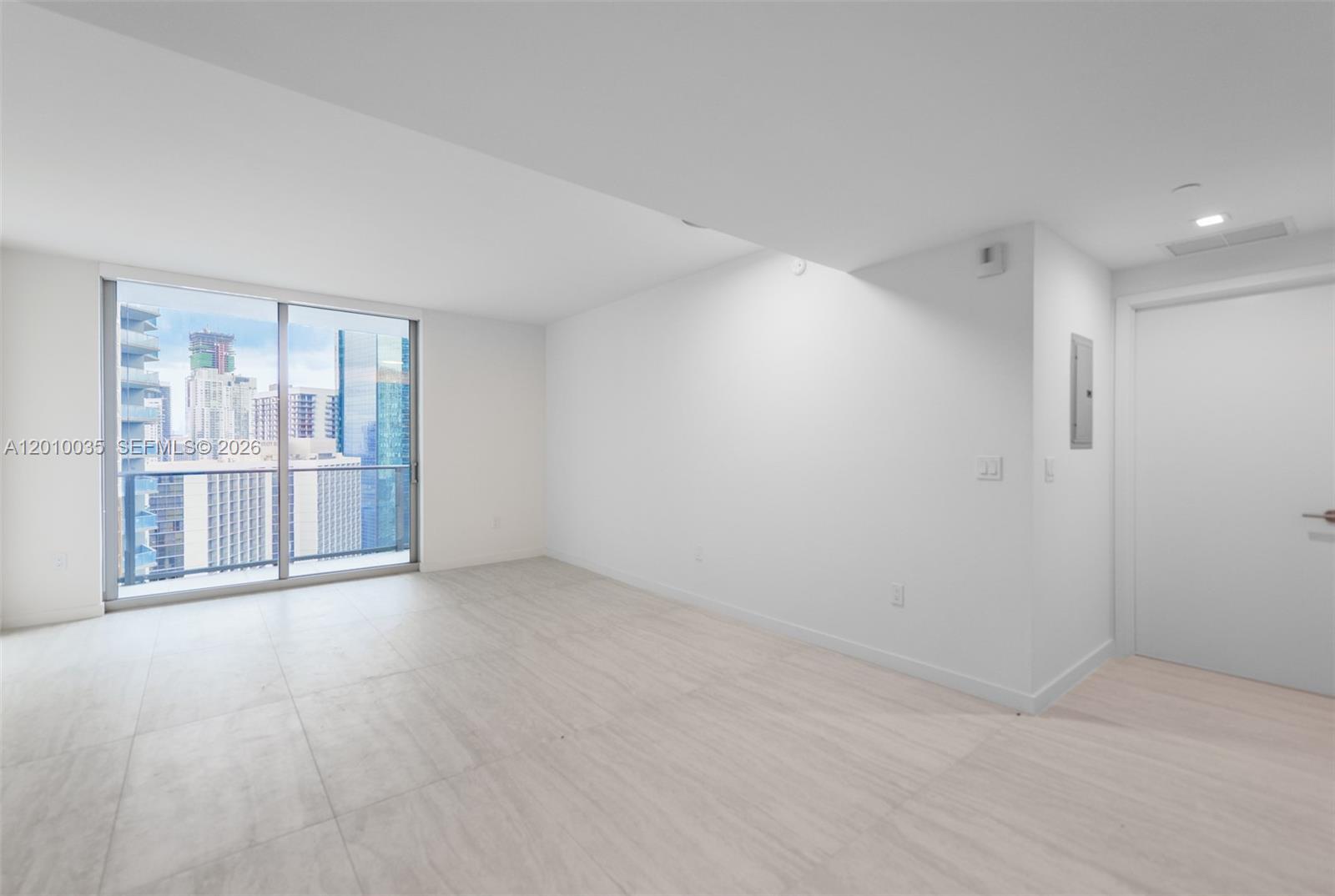 77 Southeast 5th Street, Unit 2603 Miami, FL 33131 - Photo 3 of 67 a view of an empty room with a window