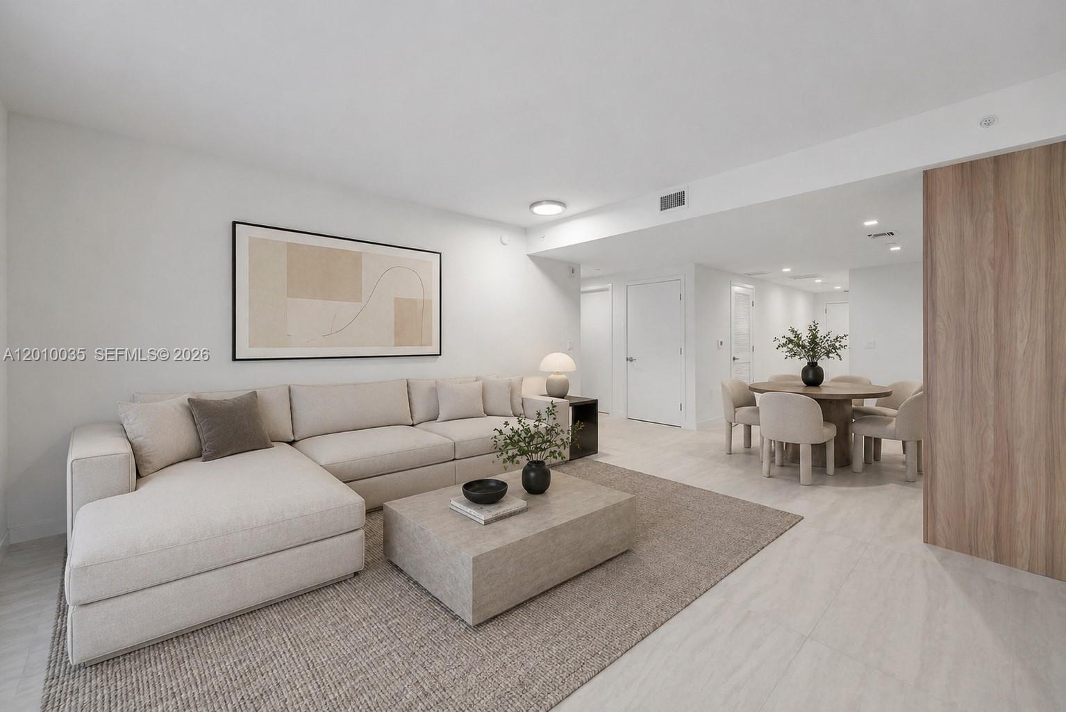 77 Southeast 5th Street, Unit 2603 Miami, FL 33131 - Photo 8 of 67 a living room with furniture and a mirror