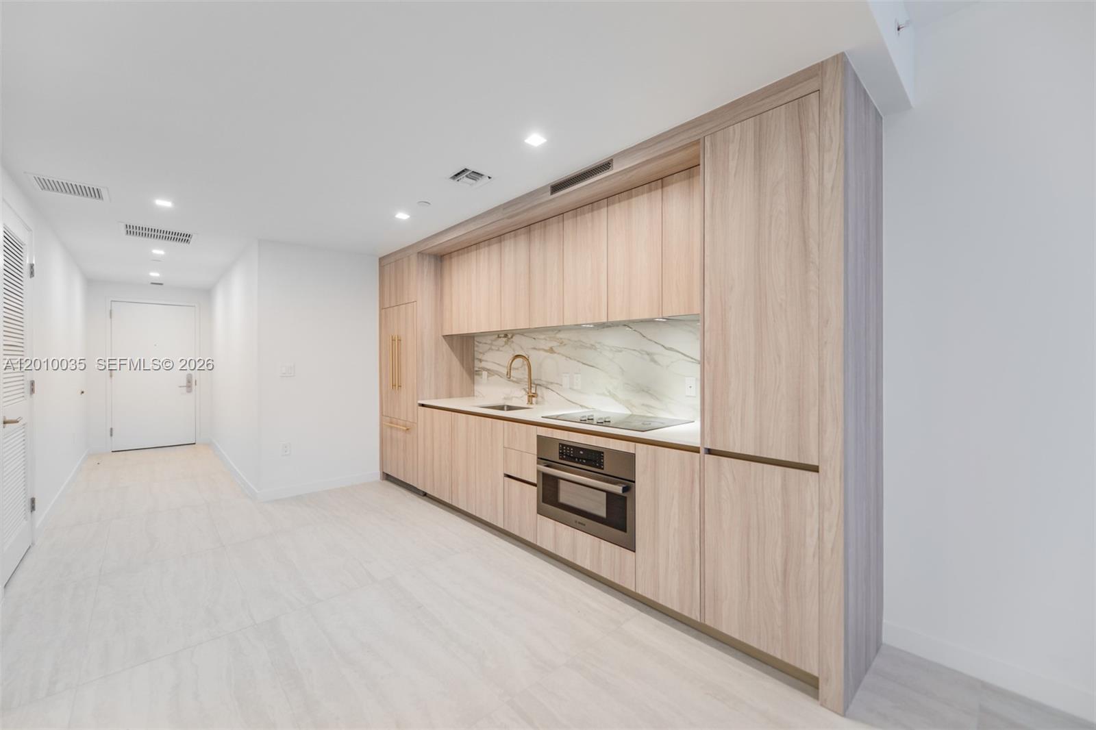 77 Southeast 5th Street, Unit 2603 Miami, FL 33131 - Photo 9 of 67 a kitchen with stainless steel appliances granite countertop a refrigerator and a sink