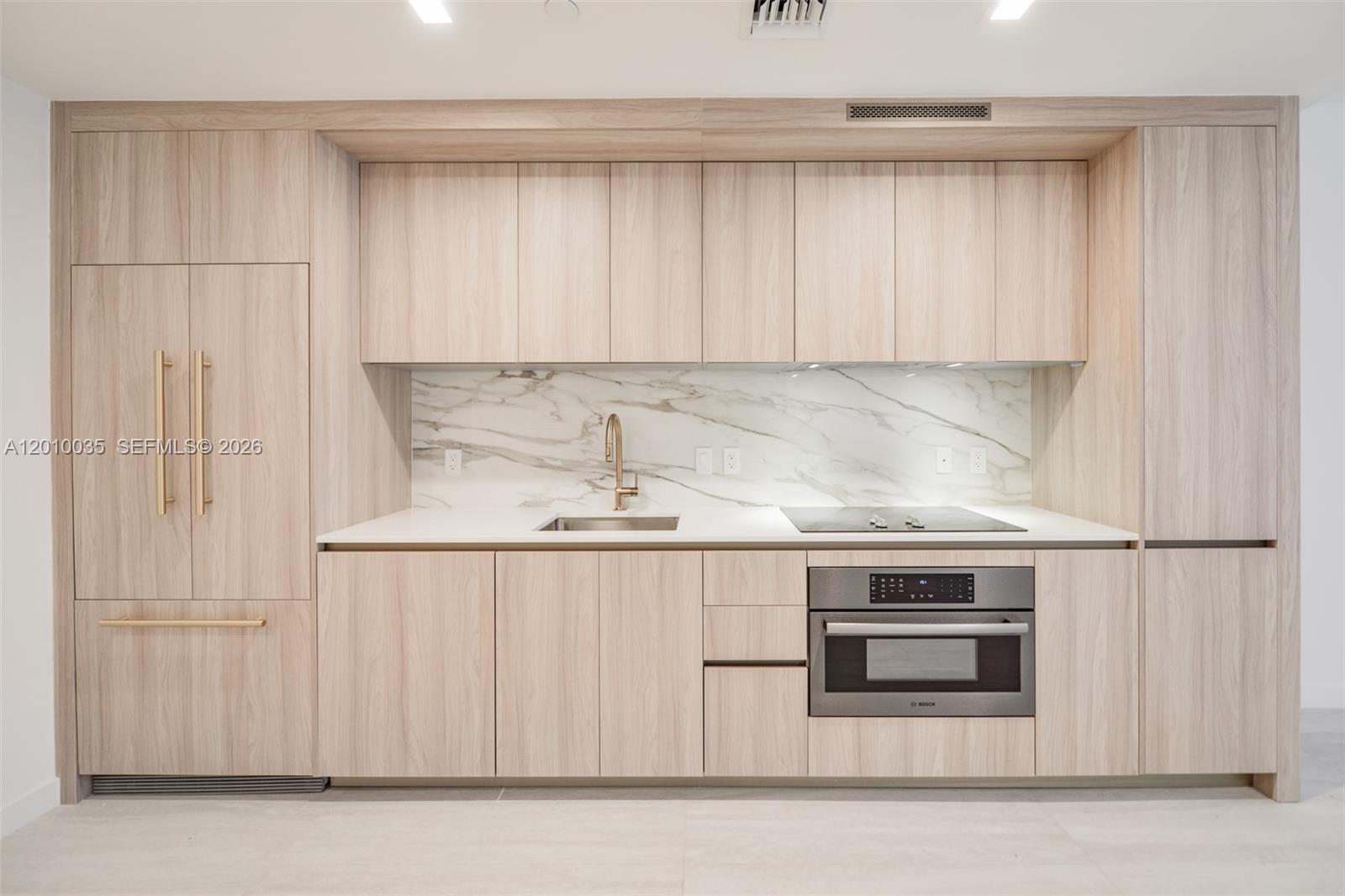 77 Southeast 5th Street, Unit 2603 Miami, FL 33131 - Photo 10 of 67 a kitchen with granite countertop white cabinets and stainless steel appliances