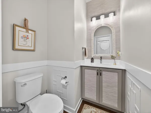 a bathroom with a toilet a sink and mirror