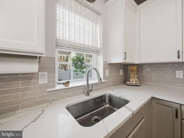 a kitchen with a sink cabinets and window