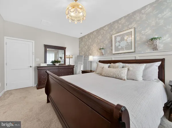 a bedroom with bed and a chandelier