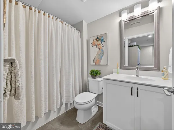 a bathroom with a toilet a sink and a mirror