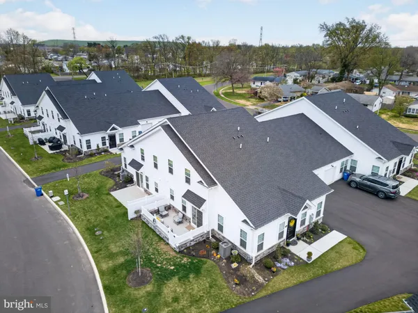 an aerial view of multiple houses with yard