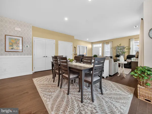 a view of a a dining room with furniture window and wooden floor