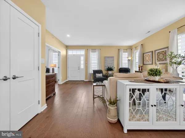 a living room with furniture wooden floor and a window