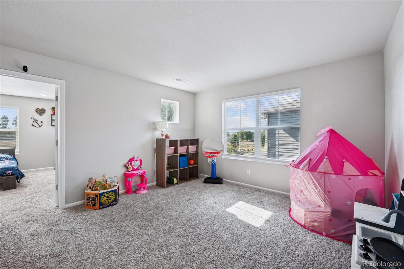 5097 Buckwheat Road Brighton, CO 80640 - Photo 12 of 28 a living room with furniture a couch and a window