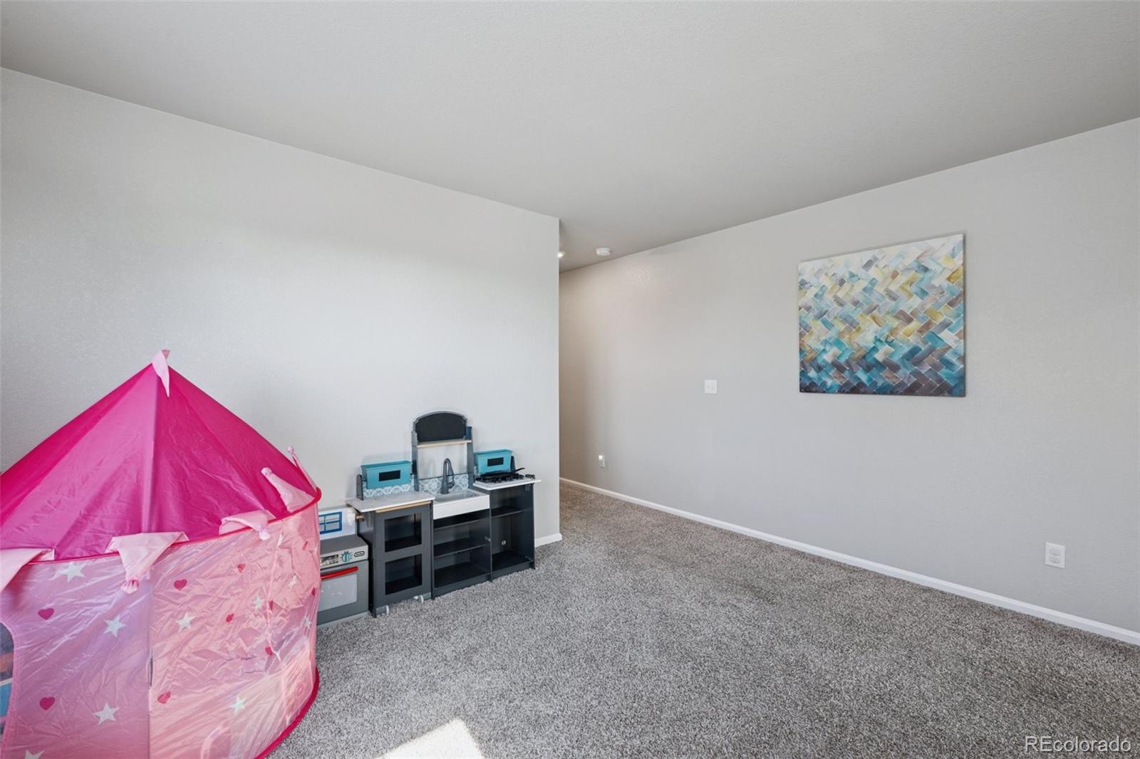5097 Buckwheat Road Brighton, CO 80640 - Photo 13 of 28 a bedroom with a bed and a desk