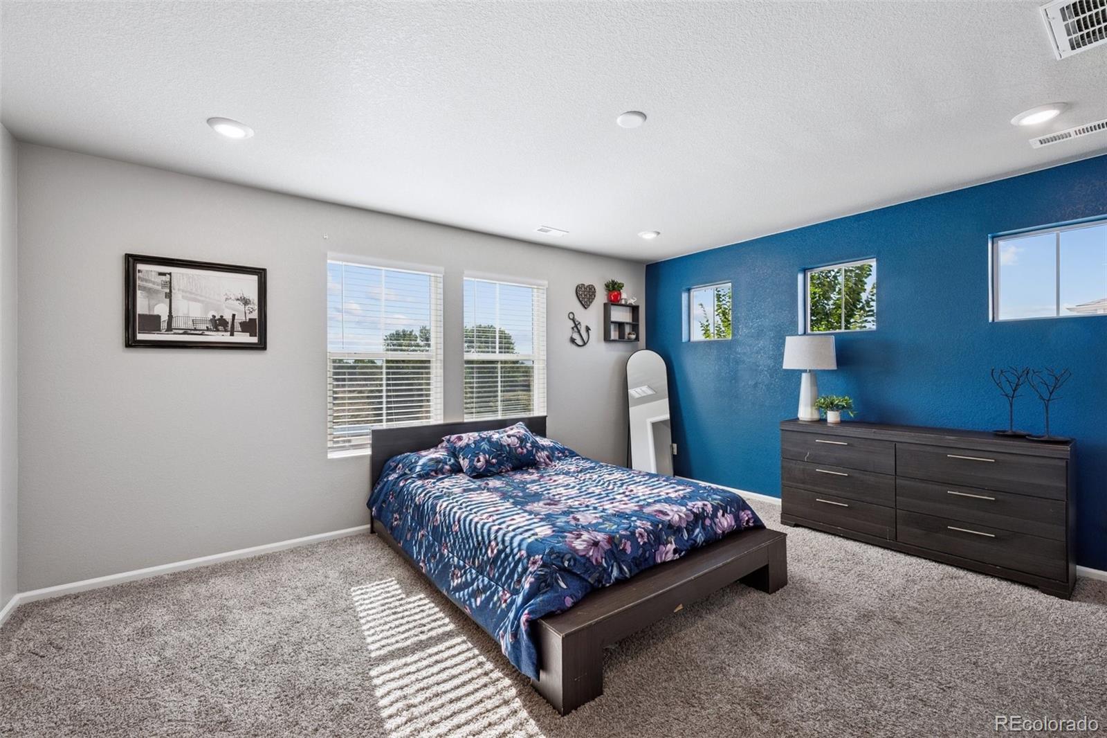 5097 Buckwheat Road Brighton, CO 80640 - Photo 15 of 28 a bedroom with a bed and window
