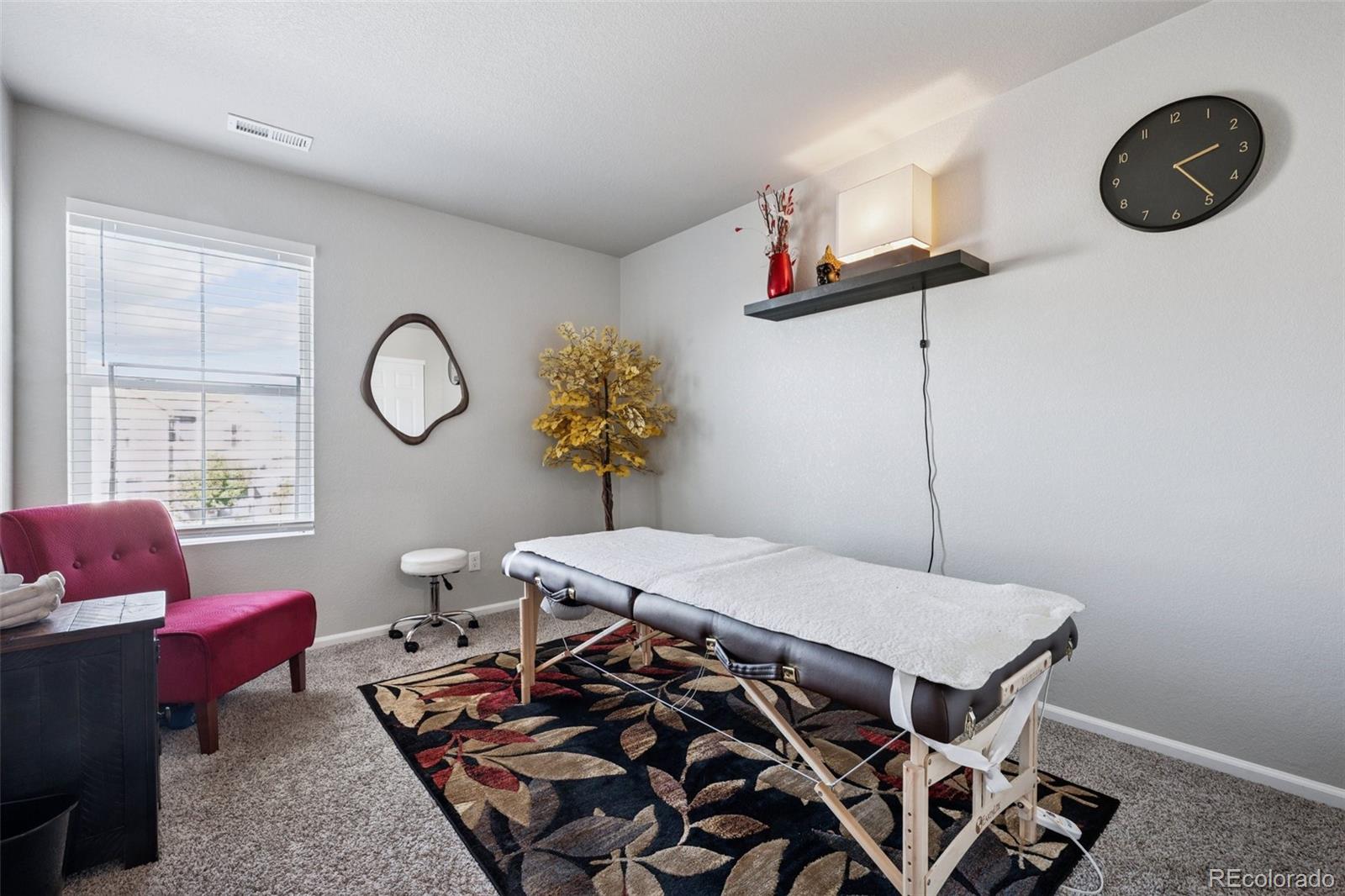 5097 Buckwheat Road Brighton, CO 80640 - Photo 19 of 28 a living room with a couch and a chandelier