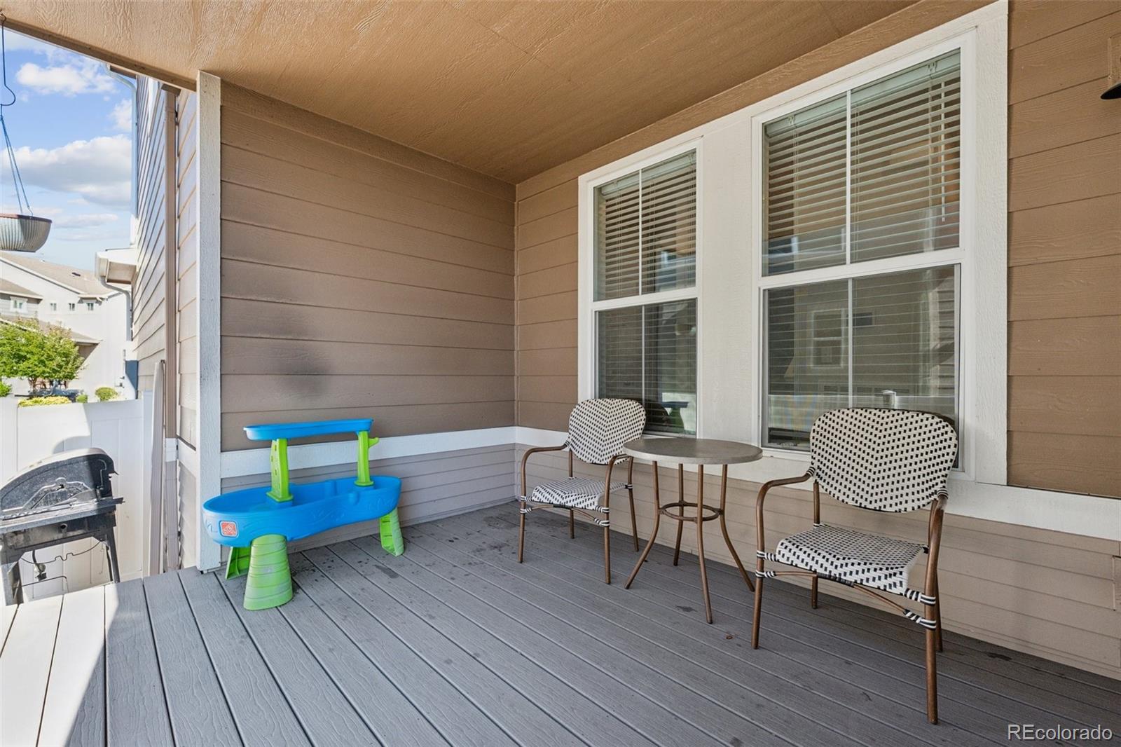 5097 Buckwheat Road Brighton, CO 80640 - Photo 20 of 28 a living room with furniture and a wooden floor