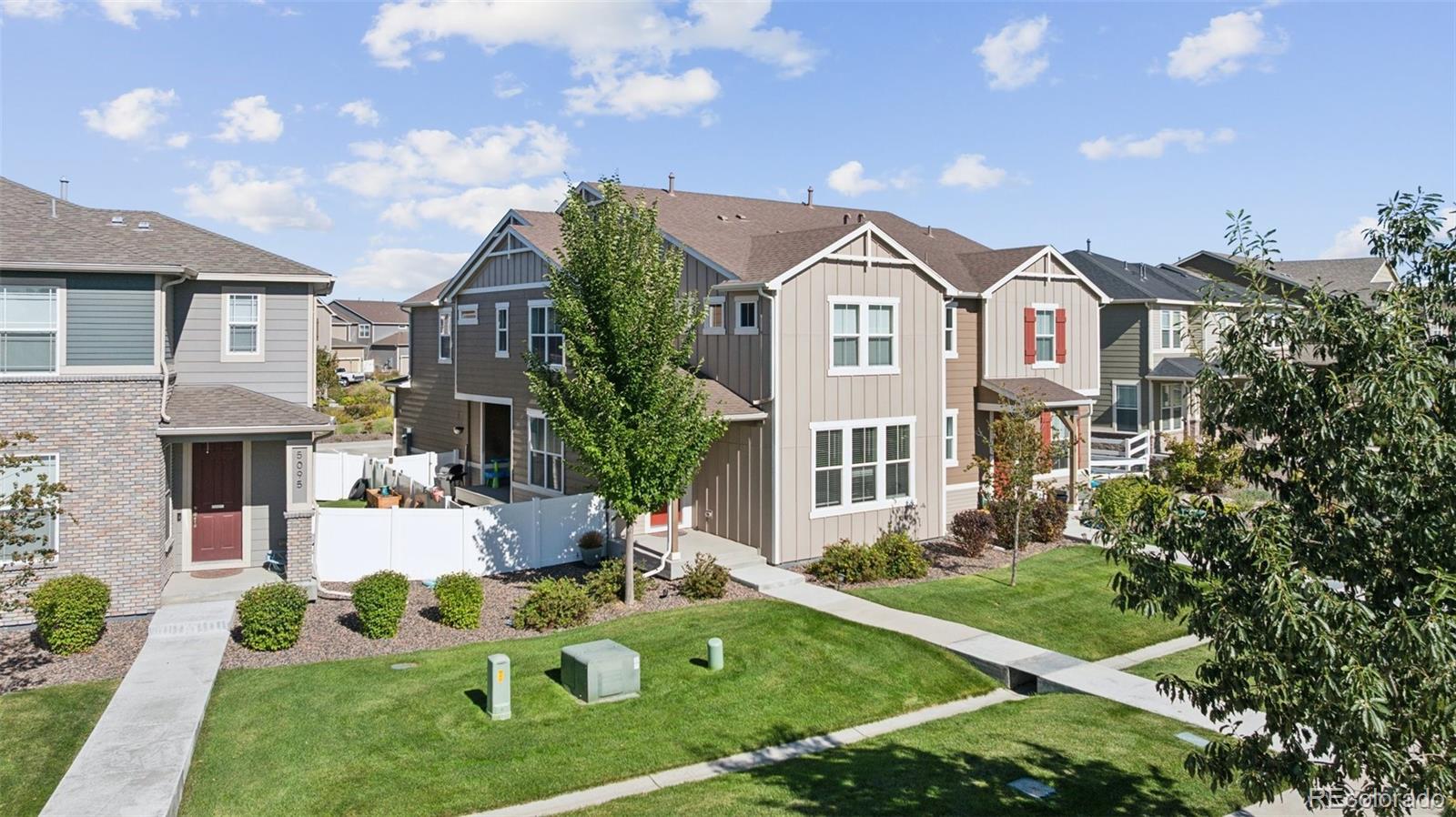 5097 Buckwheat Road Brighton, CO 80640 - Photo 3 of 28 a front view of a house with a yard