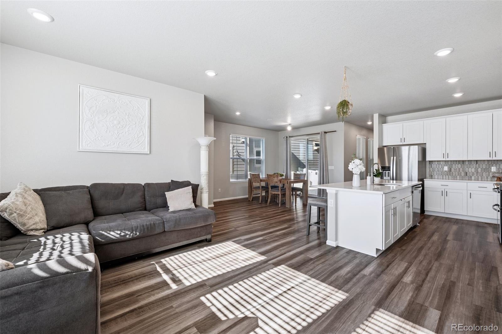 5097 Buckwheat Road Brighton, CO 80640 - Photo 6 of 28 a living room with furniture kitchen view and a table