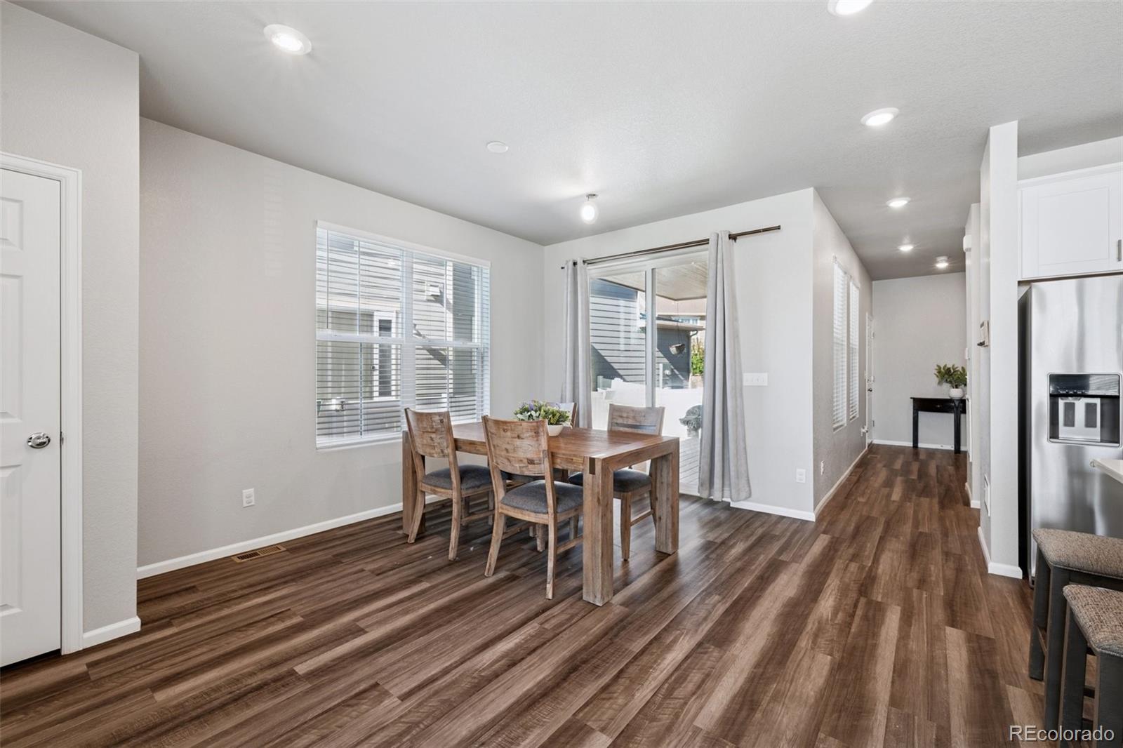 5097 Buckwheat Road Brighton, CO 80640 - Photo 7 of 28 a view of a dining room with furniture window and wooden floor