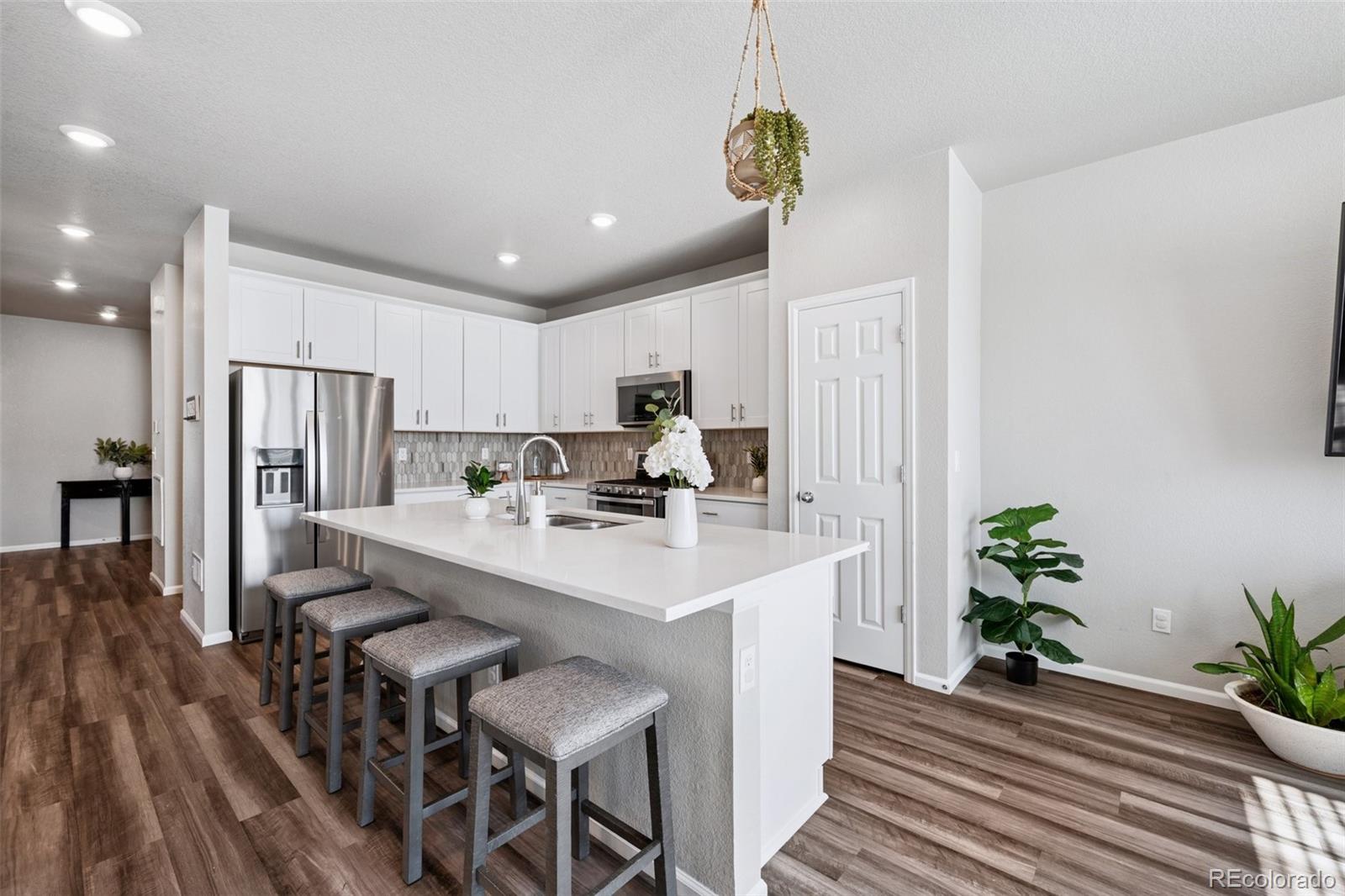 5097 Buckwheat Road Brighton, CO 80640 - Photo 8 of 28 a view of kitchen with sink microwave and dining table