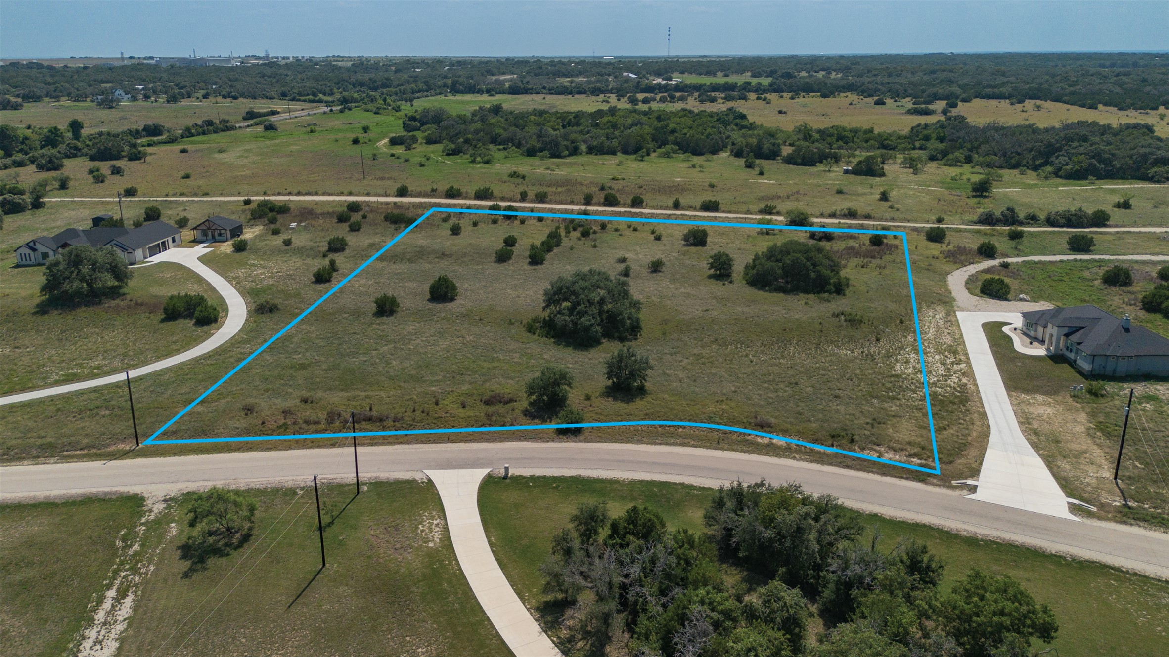 Lot 3 Cloudwood Ranch Road Briggs, TX 78608 - Photo 11 of 13 A spacious, buildable lot awaits your dream home, nestled amidst a tranquil, verdant landscape.