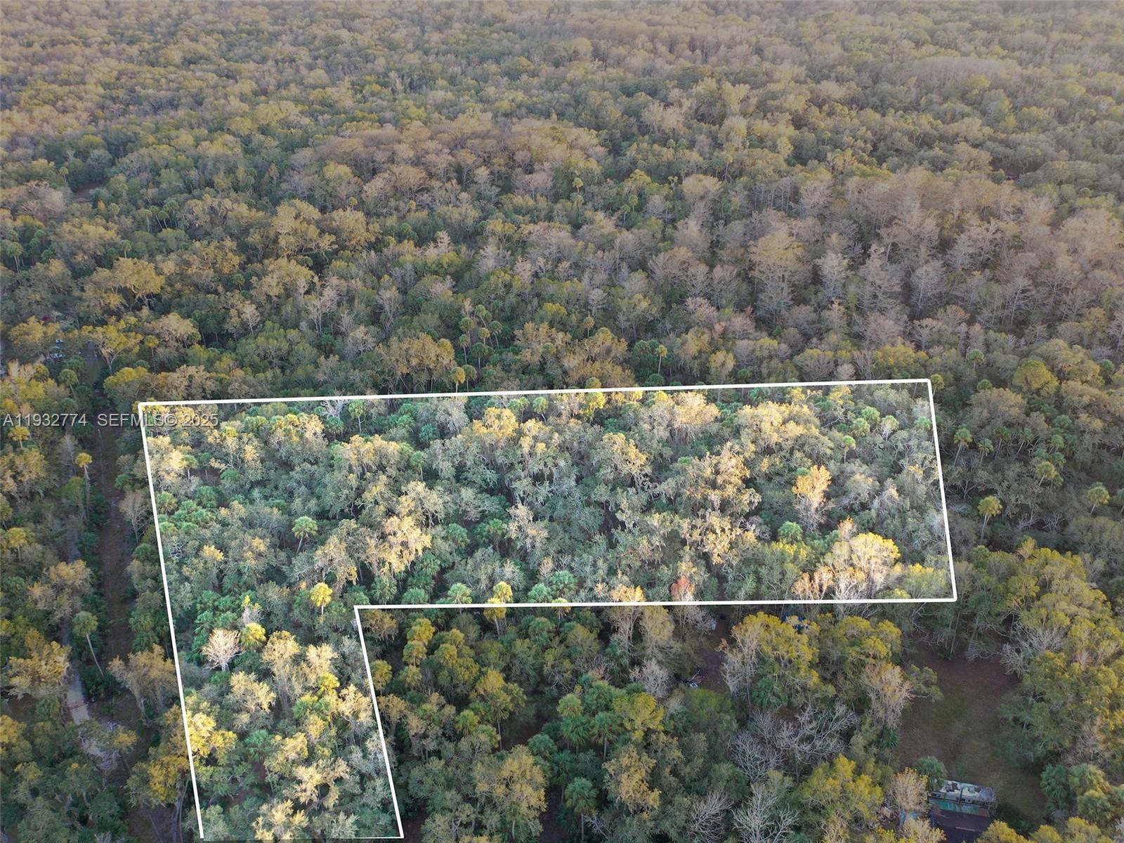 13254 East Shawnee Trail Inverness, FL 34450 - Photo 2 of 24 an aerial view of a house with a yard and lake view