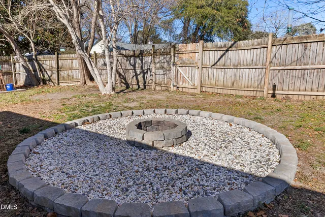 a view of a patio with a table chairs and wooden fence