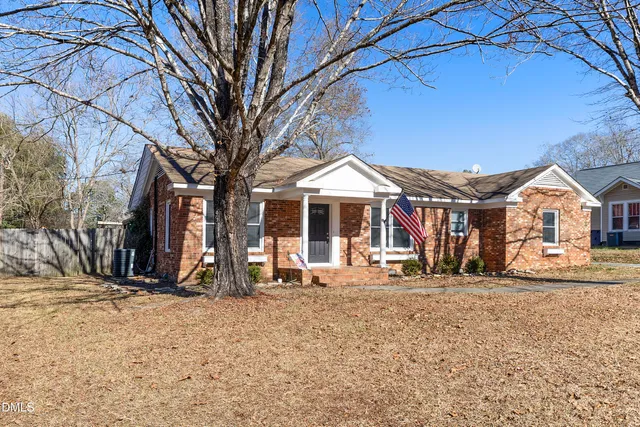 a group of people sitting in front of a house