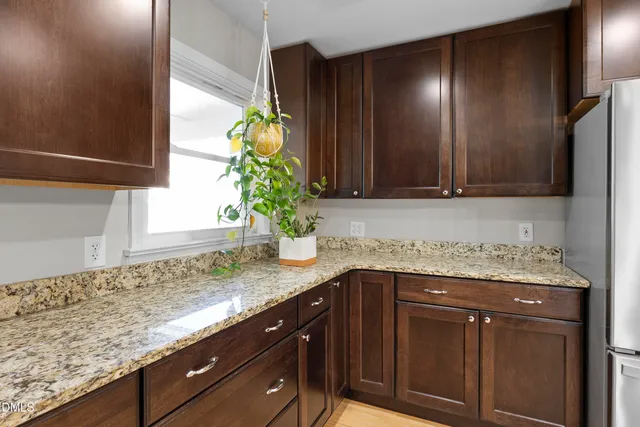 a view of a livingroom with a window and wooden floor