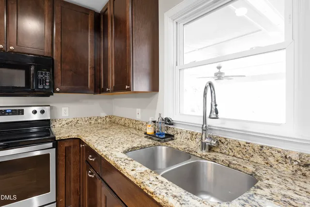 a view of an empty room and window with wooden floor