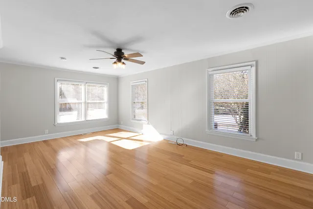 a view of a house with wooden fence